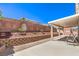 Expansive backyard features a covered patio, low-maintenance landscaping, and privacy wall at 1073 Nordyke Ave, Henderson, NV 89015