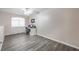Neutral bedroom features wood-look floors, ceiling fan, and desk by window at 1073 Nordyke Ave, Henderson, NV 89015