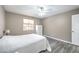 Comfortable bedroom with neutral walls, ceiling fan, window, and bright white trim at 1073 Nordyke Ave, Henderson, NV 89015