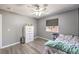 Bedroom features wood-look floors, ceiling fan, dresser and window at 1073 Nordyke Ave, Henderson, NV 89015