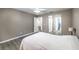 Relaxing bedroom with neutral walls, bright white trim, ceiling fan, and two closets at 1073 Nordyke Ave, Henderson, NV 89015