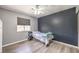 Bedroom features wood-look floors, ceiling fan, and desk by window at 1073 Nordyke Ave, Henderson, NV 89015