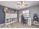 Cozy bedroom features a storage shelf and a modern desk area by window at 1073 Nordyke Ave, Henderson, NV 89015