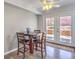 View of the dining area which features wood-look flooring and direct access to the backyard through glass doors at 1073 Nordyke Ave, Henderson, NV 89015