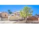 Two-story home featuring a neutral stucco exterior, desert landscaping, and an attached two-car garage at 1073 Nordyke Ave, Henderson, NV 89015