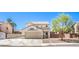 Two-story home showcasing a neutral stucco exterior, a two-car garage, and desert landscaping at 1073 Nordyke Ave, Henderson, NV 89015
