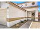 View of the front entrance that shows the front door, decorative diamond-shaped windows, and desert landscaping at 1073 Nordyke Ave, Henderson, NV 89015
