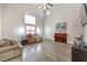 Bright living room featuring tall ceilings, wood-look flooring, large windows, and a cozy seating area at 1073 Nordyke Ave, Henderson, NV 89015