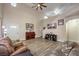 Spacious living room with tall ceilings, wood-look flooring, ample natural light, and comfortable furnishings at 1073 Nordyke Ave, Henderson, NV 89015