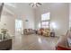 Open-concept living room with tall ceilings, wood-look flooring, bright lighting, and comfortable sofas at 1073 Nordyke Ave, Henderson, NV 89015