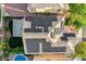 A top-down view of solar panels, patio, grass, landscaping, pool, and roof on a well maintained home at 10988 Salernes St, Las Vegas, NV 89141