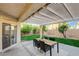 Charming backyard featuring a covered patio, dining area, and well-manicured lawn, ideal for relaxation and gatherings at 10988 Salernes St, Las Vegas, NV 89141