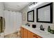 Bathroom featuring a double vanity with dark fixtures and a shower with white curtain at 10988 Salernes St, Las Vegas, NV 89141