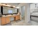 Bathroom showcasing a double vanity, large mirror, and entrance to the bedroom offering a seamless and convenient transition at 10988 Salernes St, Las Vegas, NV 89141