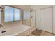 Bathroom featuring a soaking tub, tiled floors, and glass shower door at 10988 Salernes St, Las Vegas, NV 89141