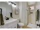 Modern bathroom featuring white fixtures, a glass-enclosed shower, and neutral tones at 10988 Salernes St, Las Vegas, NV 89141