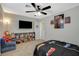 bedroom with a ceiling fan, a tv, and a play area with toys and a Spiderman theme at 10988 Salernes St, Las Vegas, NV 89141