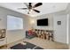 Bedroom with a ceiling fan, a tv, and a play area with toys at 10988 Salernes St, Las Vegas, NV 89141
