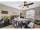 Spacious bedroom featuring a ceiling fan, natural light, and fun dinosaur-themed decor at 10988 Salernes St, Las Vegas, NV 89141