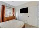 Comfortable bedroom with natural light, TV, and ample closet space at 10988 Salernes St, Las Vegas, NV 89141