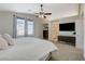 Bedroom featuring neutral paint, ceiling fan, carpet, and entry view to bathroom at 10988 Salernes St, Las Vegas, NV 89141