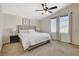Bedroom with a ceiling fan, neutral paint, and natural lighting from two windows at 10988 Salernes St, Las Vegas, NV 89141