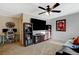 Enjoy a casual bonus room with comfortable seating, television, ceiling fan, and a work desk at 10988 Salernes St, Las Vegas, NV 89141