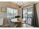 Dining area featuring a stylish table with backyard views through sliding glass doors at 10988 Salernes St, Las Vegas, NV 89141