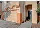 Close-up of a two-car garage and entryway with desert landscaping and a well-maintained walkway at 10988 Salernes St, Las Vegas, NV 89141