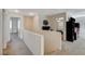Upper level hallway with neutral paint and carpet leading to various rooms at 10988 Salernes St, Las Vegas, NV 89141