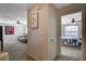 Hallway view into a bonus room and a bedroom with ceiling fans and carpeting at 10988 Salernes St, Las Vegas, NV 89141