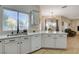 Kitchen area features stone countertops, a stainless steel sink, and backyard views at 10988 Salernes St, Las Vegas, NV 89141