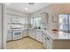 Bright kitchen features white appliances, ample counter space, and natural light from the window at 10988 Salernes St, Las Vegas, NV 89141
