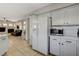 Bright kitchen features white cabinets, tile floors, and stainless microwave oven appliance at 10988 Salernes St, Las Vegas, NV 89141