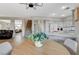 Open floor plan with a staircase, eat-in kitchen, and an adjacent living area with comfortable seating at 10988 Salernes St, Las Vegas, NV 89141