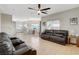 Open-concept living room and kitchen with tile floors, modern lighting, and comfortable seating at 10988 Salernes St, Las Vegas, NV 89141