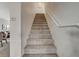 Carpeted staircase leading to the upper level of the home with white railing at 10988 Salernes St, Las Vegas, NV 89141