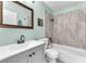 Bathroom features a white sink, toilet, and bathtub with gray marble tile surround at 110 Huckleberry Ln, Henderson, NV 89074