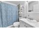 Cozy bathroom features a patterned shower curtain, white vanity, and decorative shelving at 110 Huckleberry Ln, Henderson, NV 89074