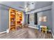 Bedroom with hardwood floors, built in shelves, large window and ceiling fan at 110 Huckleberry Ln, Henderson, NV 89074