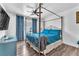 Primary bedroom featuring four-poster bed, blue decor and ceiling fan at 110 Huckleberry Ln, Henderson, NV 89074