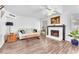 Cozy living room featuring fireplace, wood-look flooring and bright windows at 110 Huckleberry Ln, Henderson, NV 89074