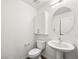 Bathroom with a pedestal sink, round mirror, and white cabinets at 12112 Polar White Ct # 3, Las Vegas, NV 89183