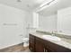 Well-lit bathroom with a granite countertop, white cabinets and tub at 12112 Polar White Ct # 3, Las Vegas, NV 89183