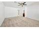 Spacious carpeted bedroom featuring a ceiling fan, neutral walls, and natural light at 12112 Polar White Ct # 3, Las Vegas, NV 89183