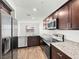 Kitchen featuring granite countertops, stainless steel appliances, and hardwood floors at 12112 Polar White Ct # 3, Las Vegas, NV 89183