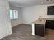 A modern kitchen featuring granite countertops, stainless steel sink, and wood-look flooring at 12112 Polar White Ct # 3, Las Vegas, NV 89183
