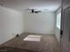 Inviting living room with plush carpet, bright windows, and modern ceiling fan at 12112 Polar White Ct # 3, Las Vegas, NV 89183