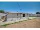 Side view of a fully fenced backyard with potential for personalization, featuring concrete and space for outdoor activities at 1816 Silver Birch Ln, Las Vegas, NV 89104