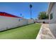 Private backyard featuring a lush lawn and tall palm tree at 1816 Silver Birch Ln, Las Vegas, NV 89104
